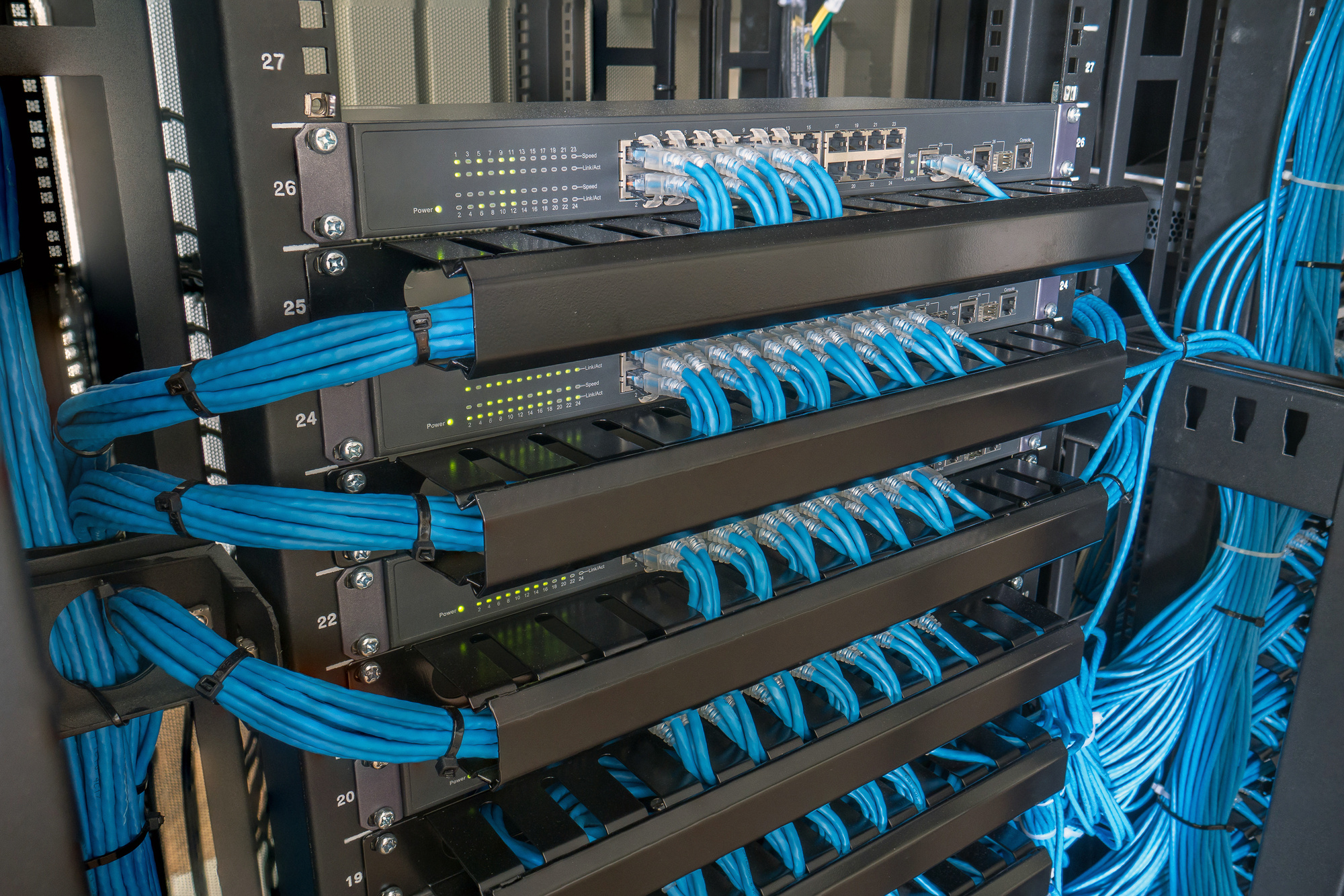 Network switch and ethernet cables in rack cabinet